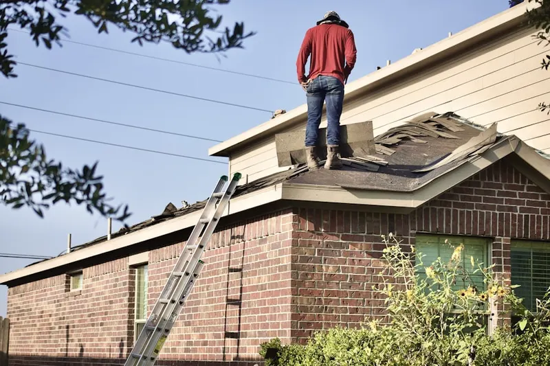 Professional roofer working on a residential roof in Greenbriar Village